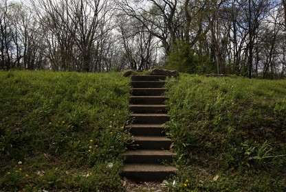 A stairway leads to an empty lot where a house used to stand.