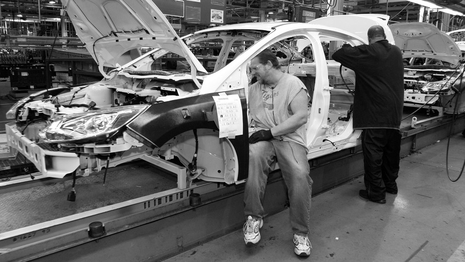 Workers build a Ford Focus on the assembly line at the Ford Motor Company's Michigan Assembly Plant on December 14, 2011, in Wayne, Michigan.