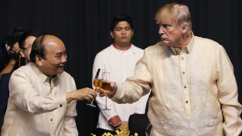 Vietnam's prime minister, Nguyen Xuan Phuc, and Donald Trump raise a glass at the Association of Southeast Asian Nations meeting in Manila in November 2017.