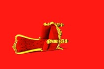 Graphic illustration of a red-and-gold throne that's been knocked over