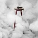 A wooden stool with a microphone on top, surrounded by smoke