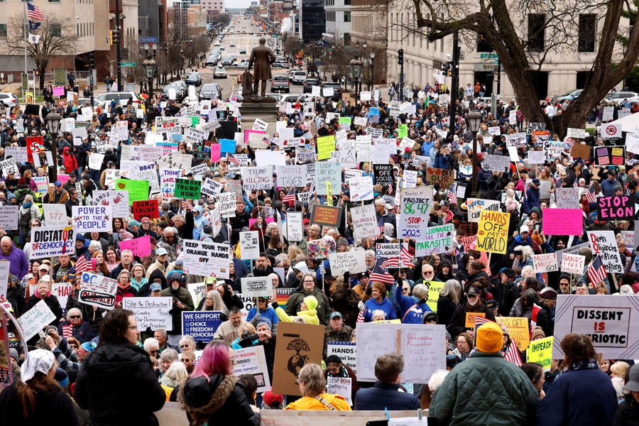 A large crowd of protesters, most carrying signs