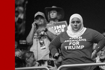 A black-and-white photo of a woman wearing an "Arab Americans for Trump" shirt