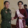 Senior General Min Aung Hlaing shakes hands with Aung San Suu Kyi.