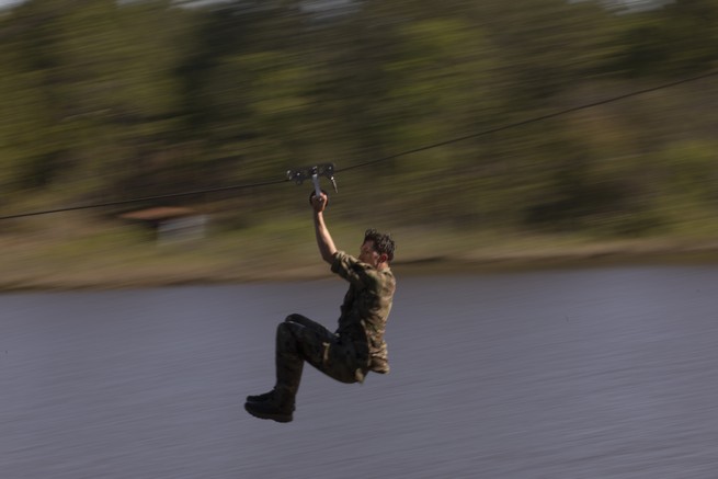 Sgt. Emerson Schroeder of the 75th Ranger Regiment slides down a zipline during the Combat Water Survival Assessment