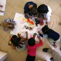 An overhead view of six pre-schoolers coloring.