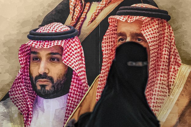 woman in niqab and abaya looks at camera while walking past a larger-than-life-size poster of the royal family
