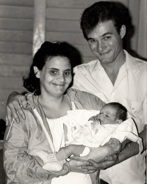 Mother and father holding a baby.