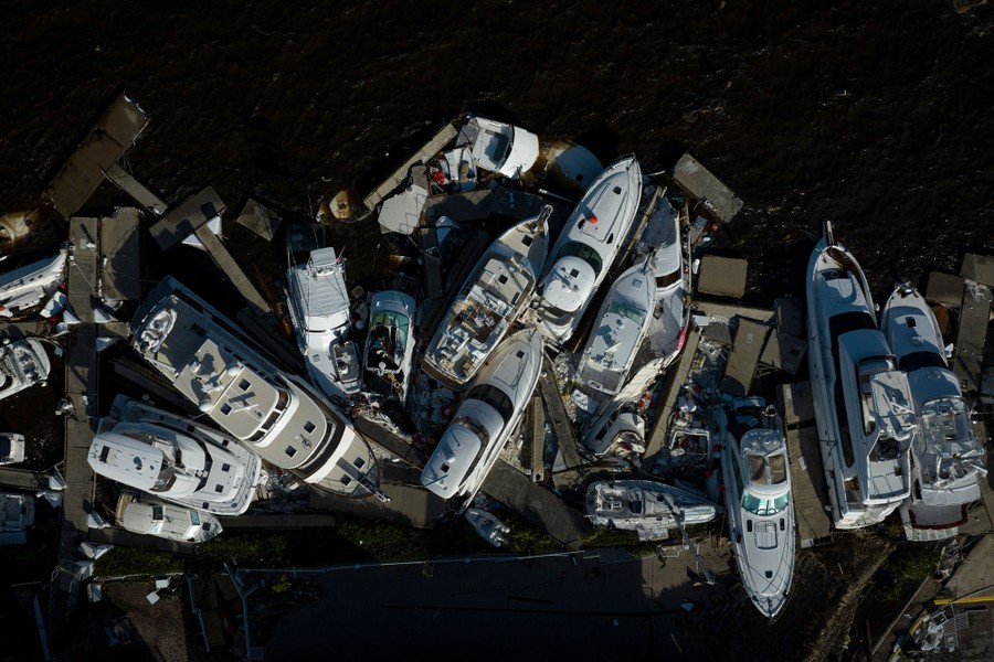 An aerial view of storm-damaged boats piled up in a harbor