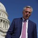U.S. House Minority Leader Kevin McCarthy walking toward the camera, with the U.S. Capitol behind him