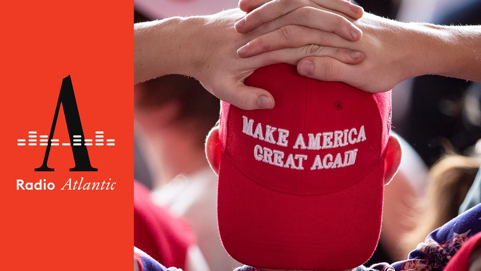 person with his hands on his head, wearing a red MAGA cap