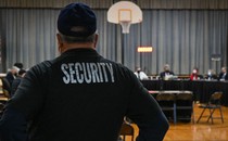 A Pennsbury School District security guard observes a Pennsbury School Board meeting in Levittown, Pennsylvania