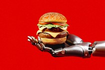 A robotic hand holds a cheeseburger