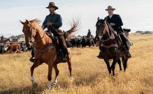Still of Paul and George on horseback in "The Power of the Dog"
