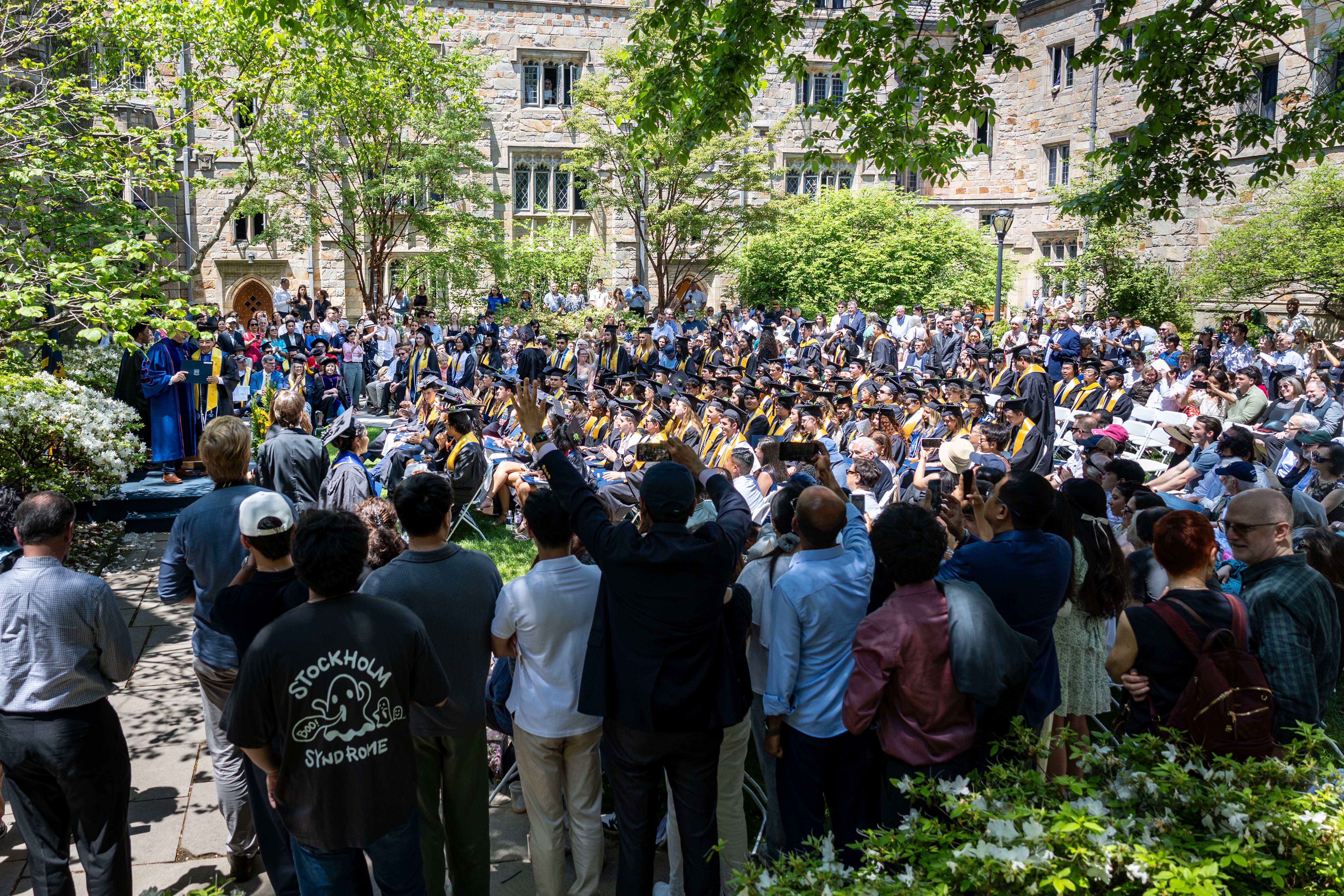 A wide view of a college-graduation ceremony in a courtyard.