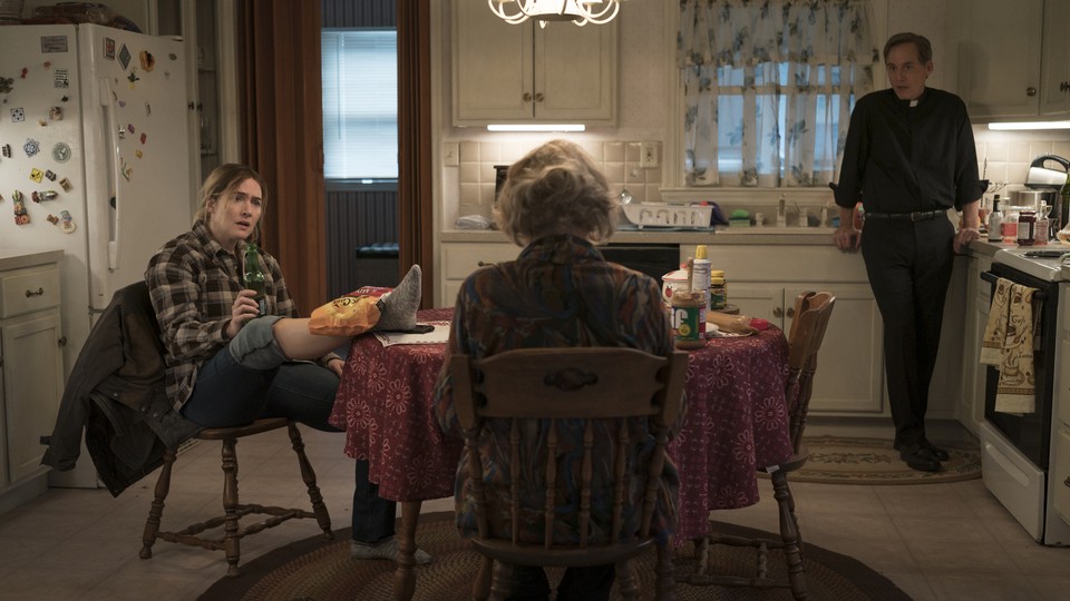 Characters from the HBO show "Mare of Easttown" gathered around a kitchen table