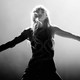 Taylor Swift in black and white with arms outstretched