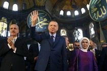 Erdoğan, center, accompanied by his wife, Emine, right, waves to supporters as he walks in the Byzantine-era Hagia Sophia, an UNESCO World Heritage site and one of Istanbul's main tourist attractions, in the historic Sultanahmet district of Istanbul. The sixth-century building is now at the center of a heated debate between conservative groups who want it to be reconverted into a mosque and those who believe the World Heritage site should remain a museum.