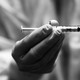 Photo of gloved hands holding a syringe
