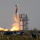 The New Shepard Blue Origin rocket lifts-off from the launch pad