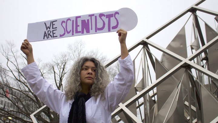 Dr. Yamilé Molina holds a sign saying ‘We Are Scientists’ during the Women’s March on Washington on Saturday, January 21, 2017. She stands next to the “Solar Delta” outdoor sculpture at the National Air and Space Museum.
