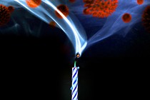 Virus particles appear in a plume of smoke coming out of a birthday candle.