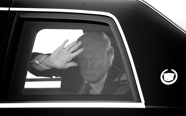 Trump waving from a car