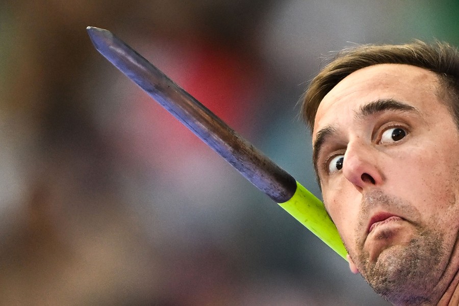 A close view of the face of an athlete about to throw a javelin.