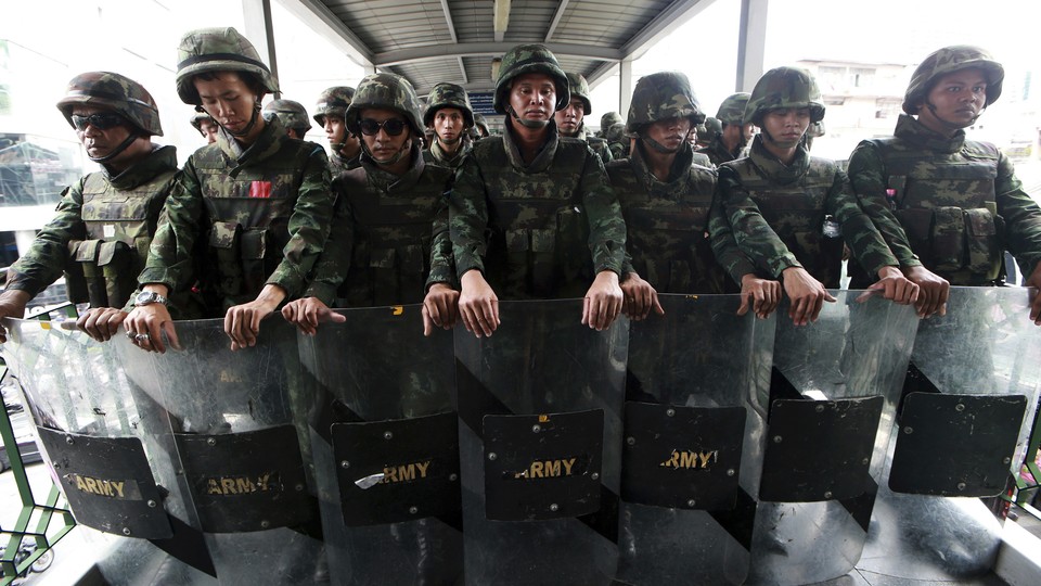 In this June 1, 2014 file photo, Thai soldiers guard an overpass to prevent anti-coup demonstration in Bangkok, Thailand.