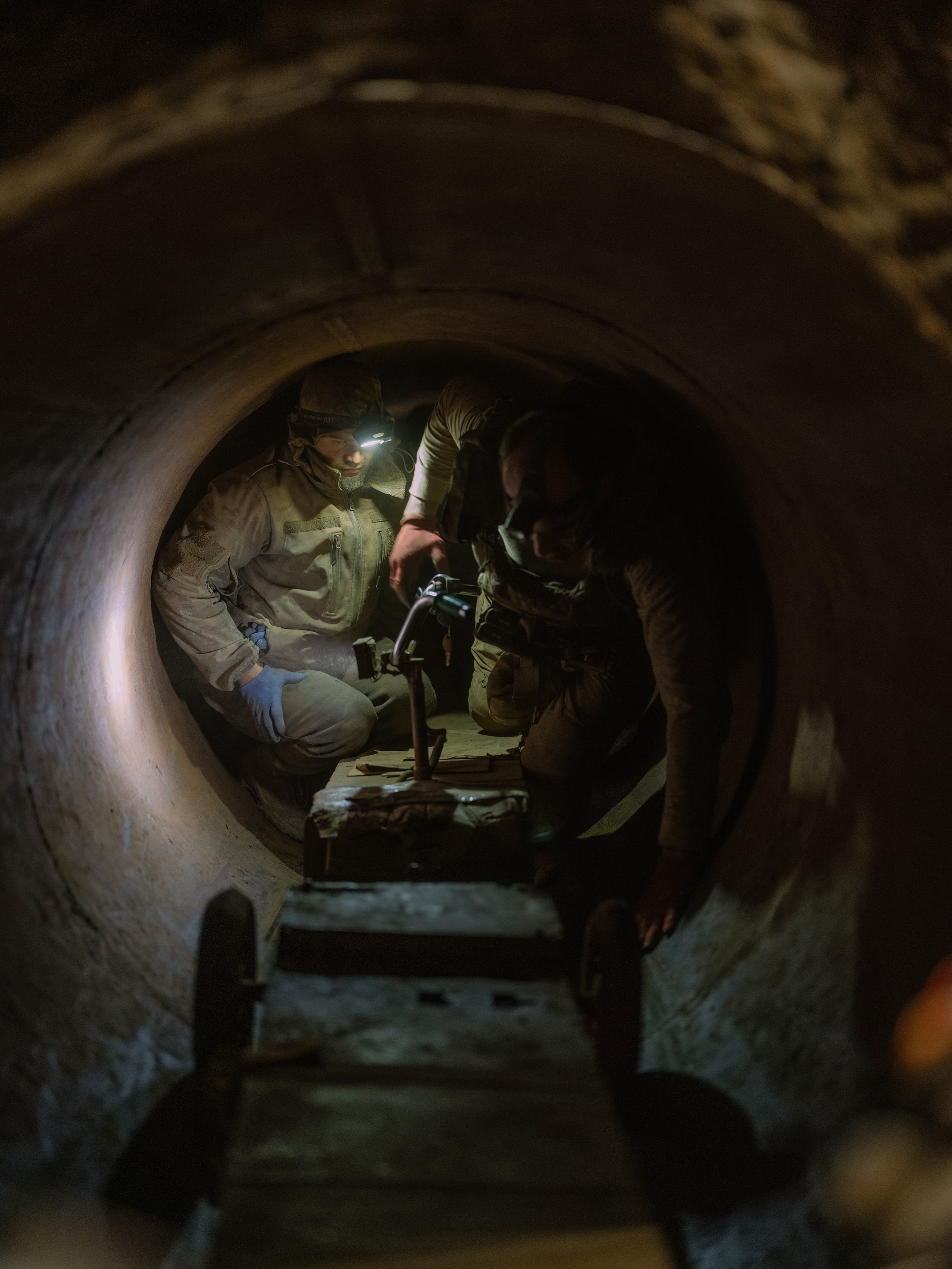 soldiers fix a scooter in a tunnel