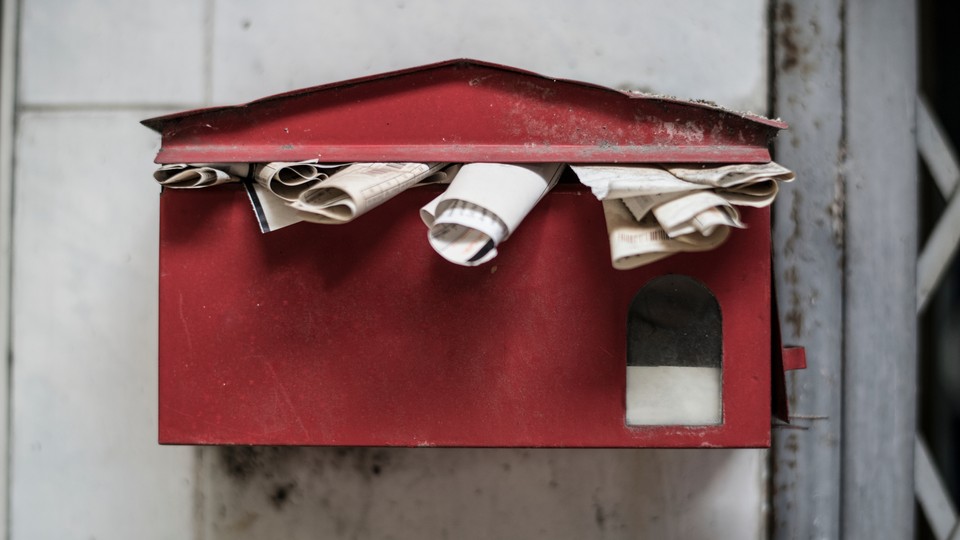 An old overflowing mailbox