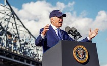 A photo of President Biden giving a speech while wearing a cap