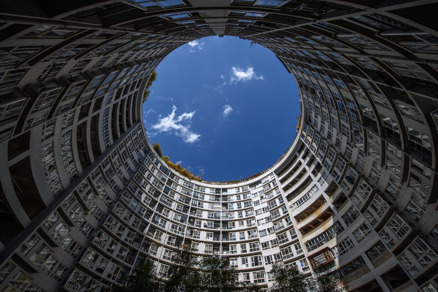 A view, looking up, of the internal courtyard of a cylindrical building in China.