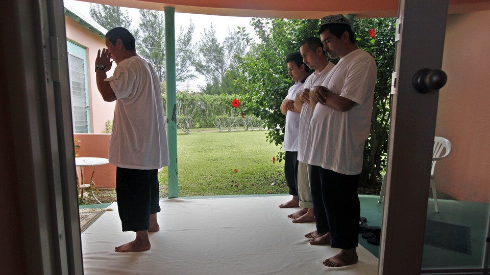 Uighur men pray together in Bermuda in 2009 days after being released from Guantánamo.
