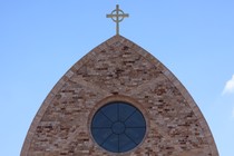 The cross atop Ave Maria Catholic Church, centrally located in Ave Maria, Florida, and across the street from Ave Maria University’s academic buildings