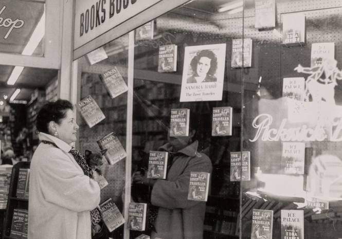 Picture of Babb in front of a window display featuring her first published book, The Lost Traveler, at Pickwick Books in Los Angeles, 1958.