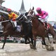 Chris Landeros aboard Bodexpress (left) races Luis Saez aboard Maximum Security (right) during the 145th running of the Kentucky Derby