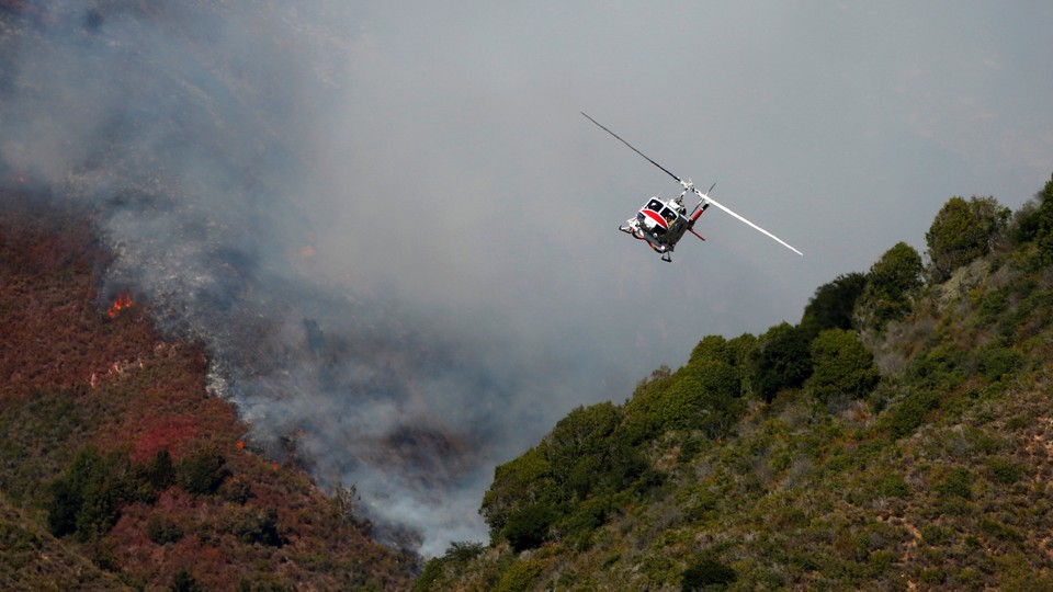 A Cal Fire helicopter flies over Garrapata State Park