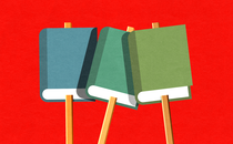 Books on sticks like picket signs against a red background
