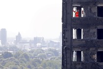 Members of the emergency services work inside the charred remains of the Grenfell Tower block on June 17, 2017.