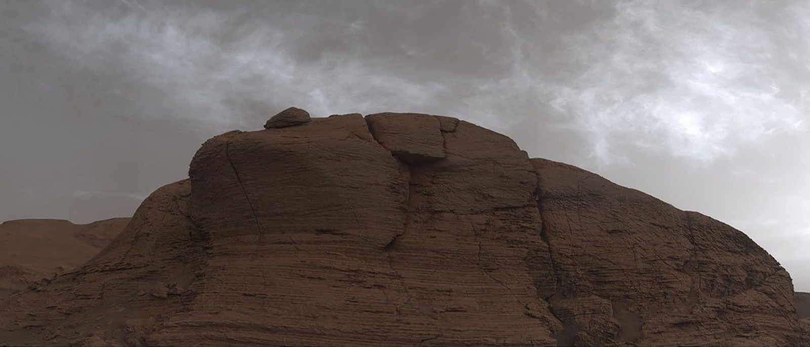 A cloudy sky above a rocky bluff