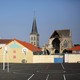 A playground is in the foreground. A church steeple is behind it.