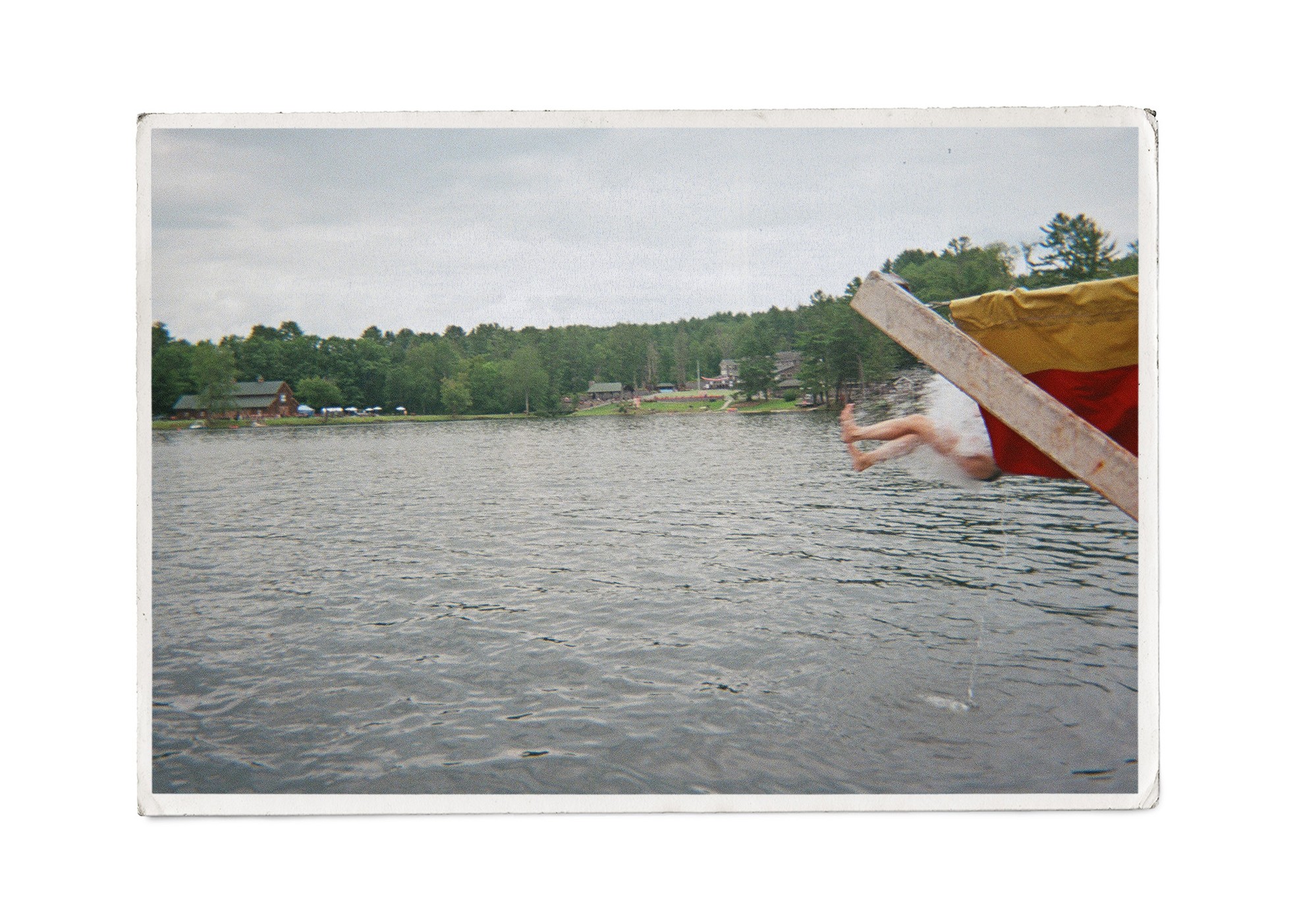 camper goes down a slide into water