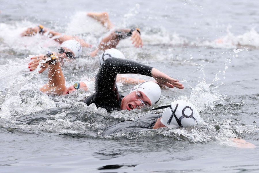 Athletes swim in an open-water race.