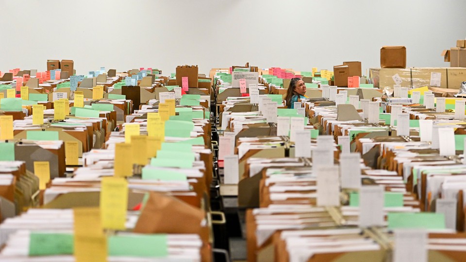 An IRS employee walks through tax documents in the staging warehouse at a Internal Revenue Service facility on March 31, 2022 in Ogden, Utah.