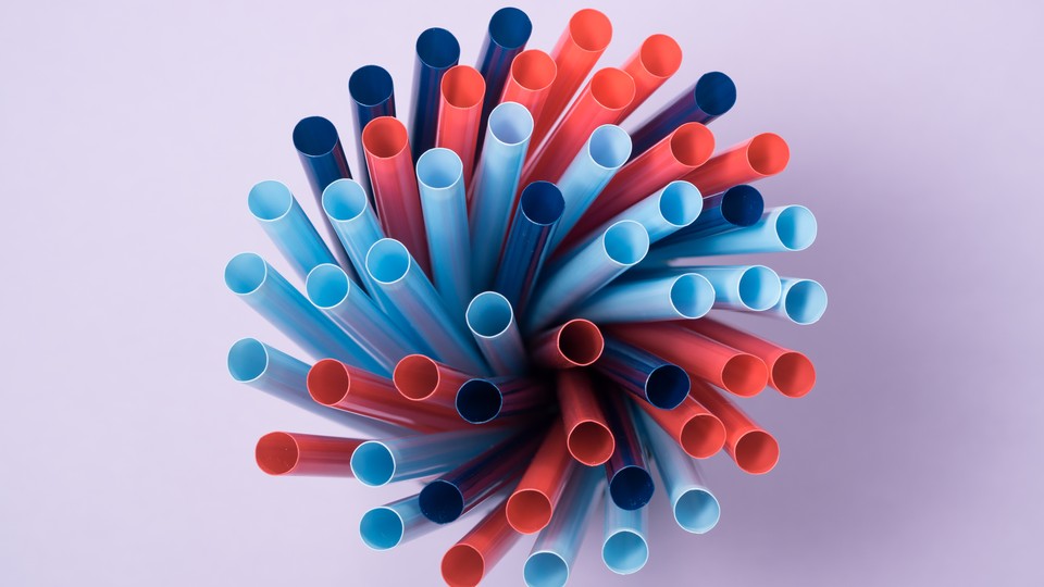A collection of pink and blue plastic straws