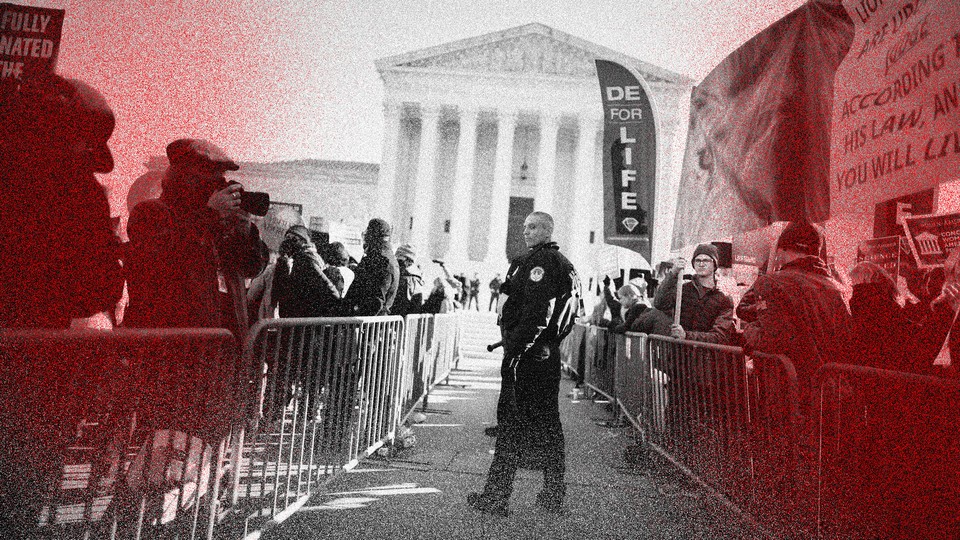 Police use metal barricades to keep protesters, demonstrators and activists apart in front of the U.S. Supreme Court