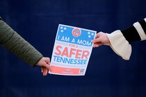 Women hold a sign as they form a human chain on the first anniversary of the Covenant School shooting in Nashville, Tennessee, March 27, 2024.