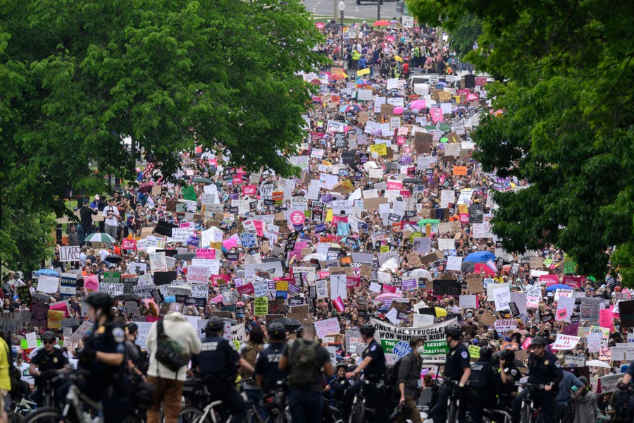 A huge crowd of abortion-rights demonstrators marches in a street.