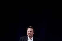 An image of Elon Musk in front of a black background, standing alone